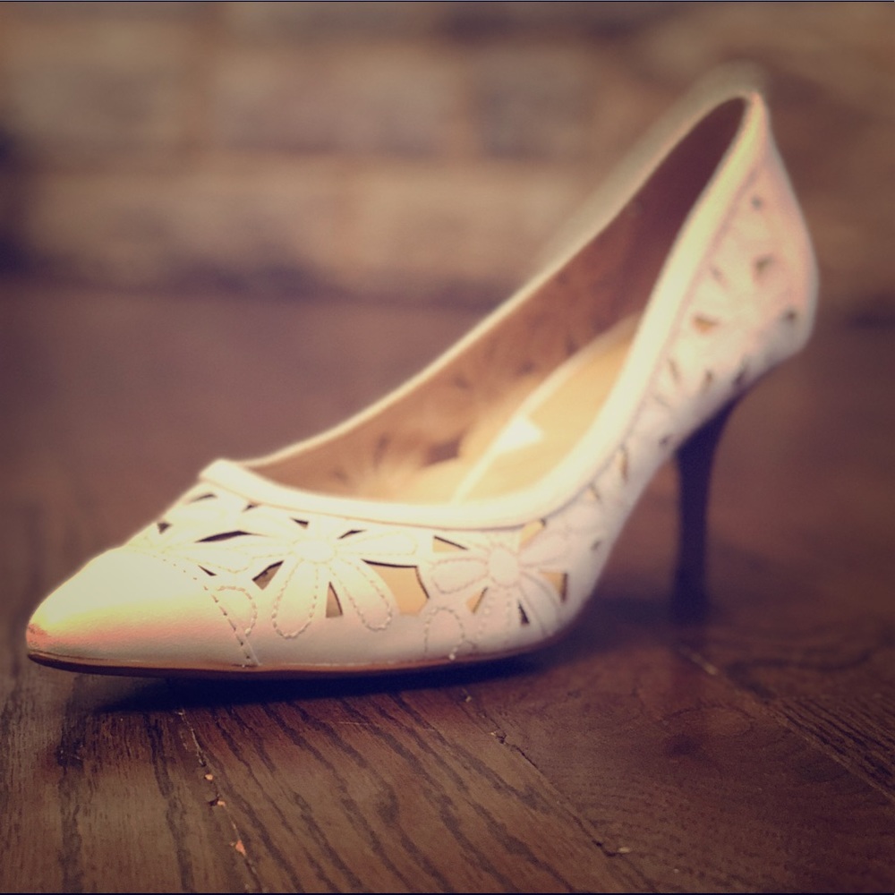 White shoes with floral accents and wooden heel
